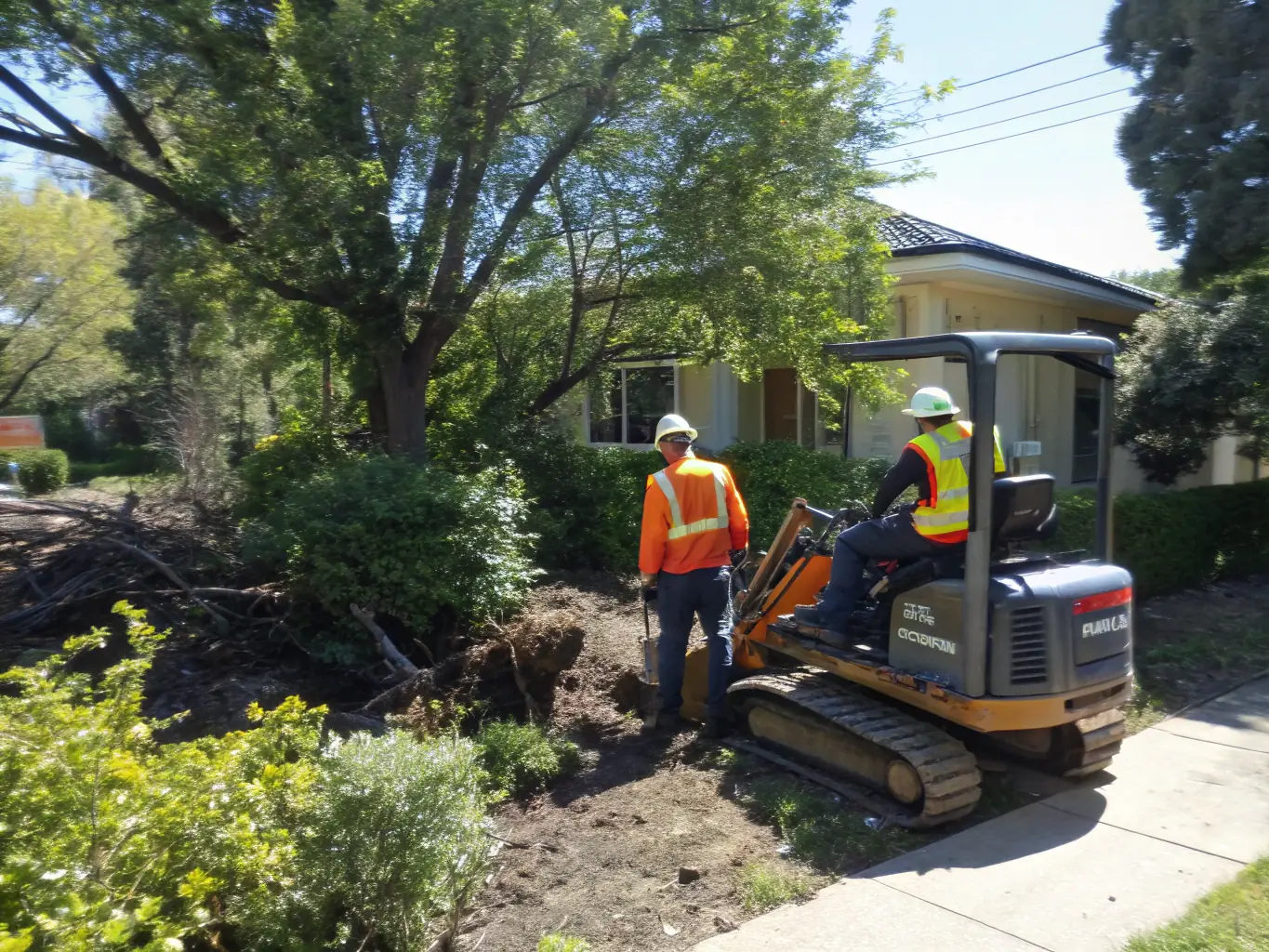 A Yanmar excavator removing brush and undergrowth from a property, highlighting the precision and effectiveness of the equipment.